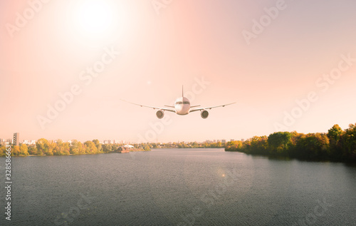 Plane over the water in the river and green forest. Landscape