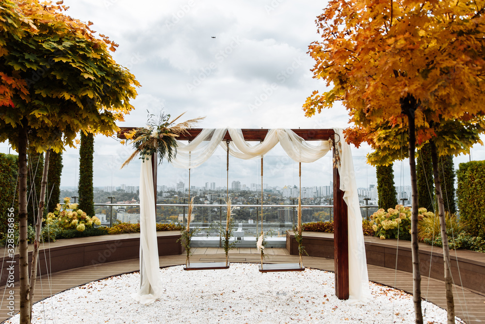 Roof swing with city view decorated with flowers Roof swing with city view decorated with flowers