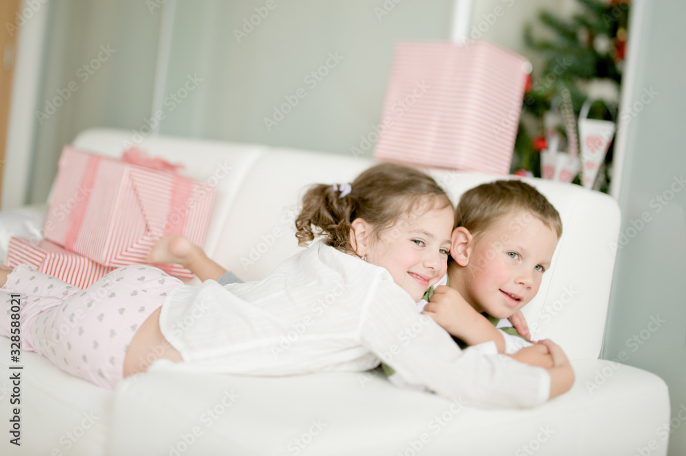 Cute children with Christmas gifts enjoying Christmas atmosphere Cute children with Christmas gifts enjoying Christmas atmosphere