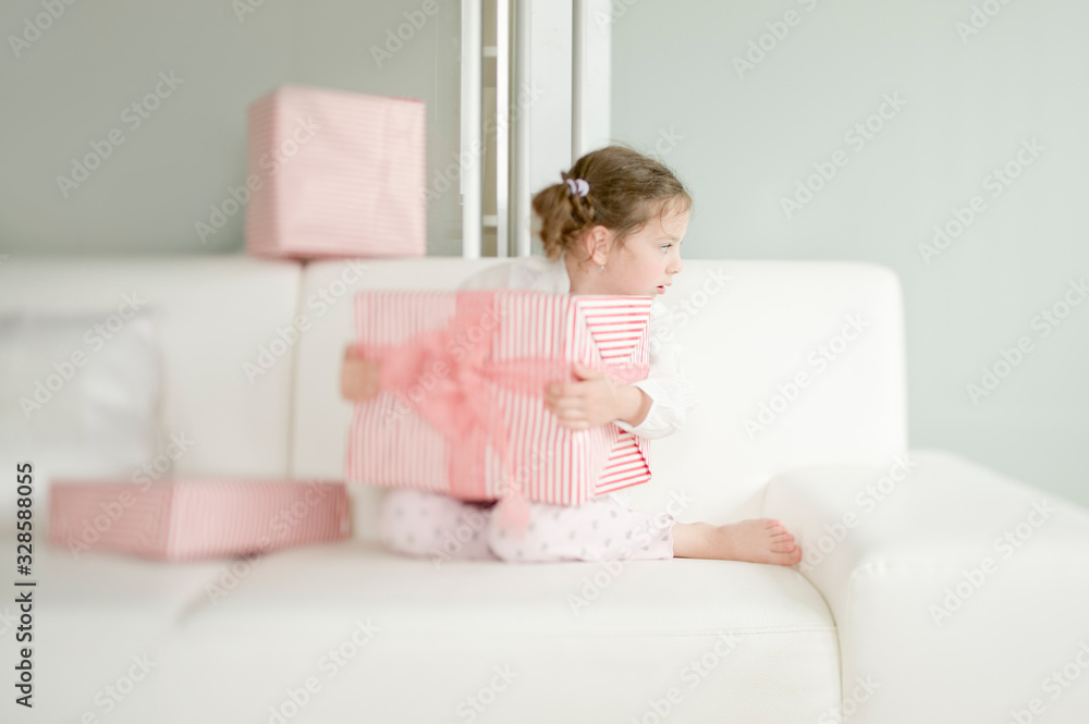 Cute child with Christmas gifts enjoying Christmas atmosphere Cute child with Christmas gifts enjoying Christmas atmosphere