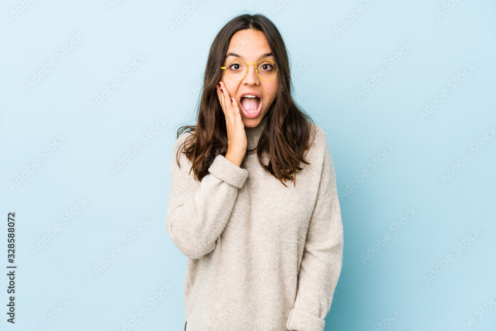 Young mixed race hispanic woman isolated shouts loud, keeps eyes opened and hands tense. Young mixed race hispanic woman isolated shouts loud, keeps eyes opened and hands tense.