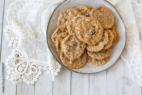 Oatmeal cookies on plate with lace and wood