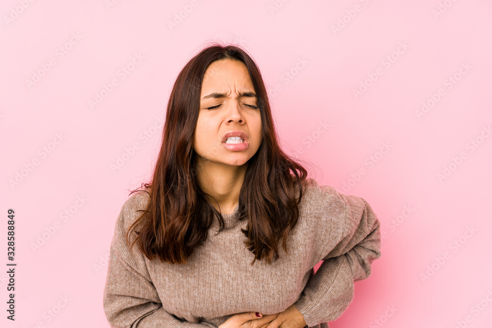 Young mixed race hispanic woman isolated having a liver pain, stomach ache. Young mixed race hispanic woman isolated having a liver pain, stomach ache.