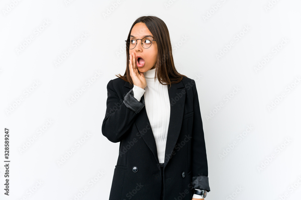 Young mixed race business woman isolated on white background is saying a secret hot braking news and looking aside Young mixed race business woman isolated on white background is saying a secret hot braking news and looking aside