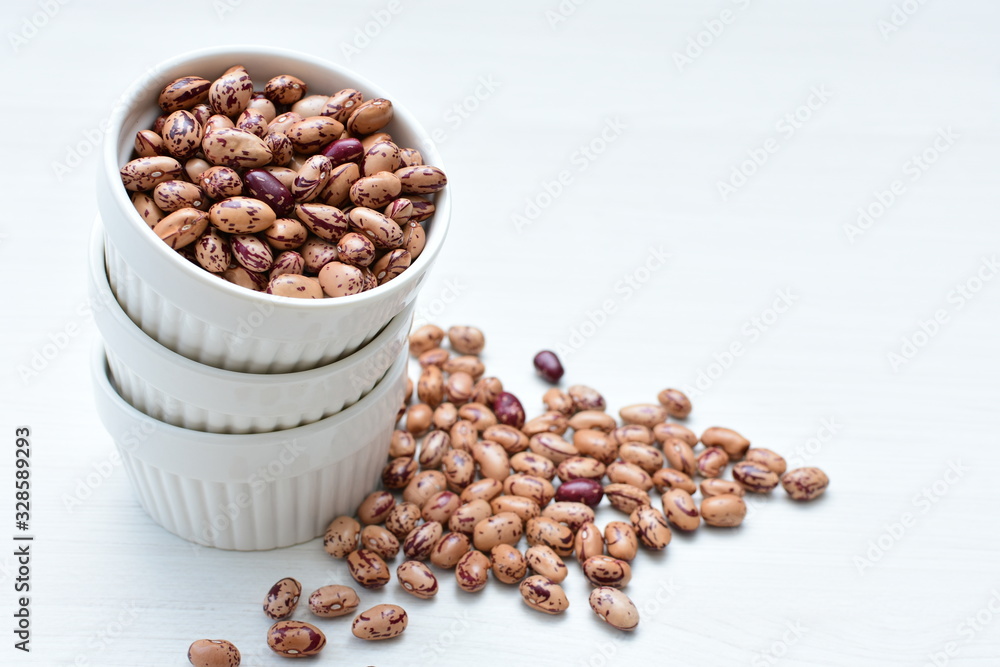 Raw bean grains (Phaseolus vulgaris) displayed in bowl Raw bean grains (Phaseolus vulgaris) displayed in bowl