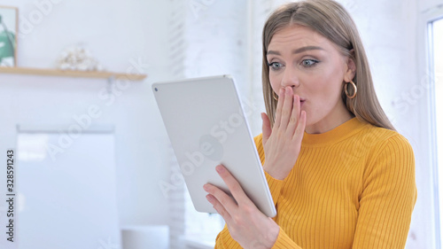 Excited Young Woman in Shock Using Tablet