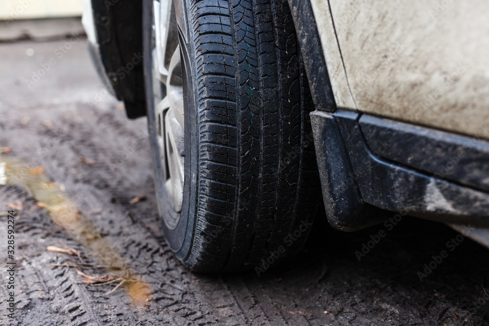 Wheel closeup in a countryside landscape with a muddy road Wheel closeup in a countryside landscape with a muddy road