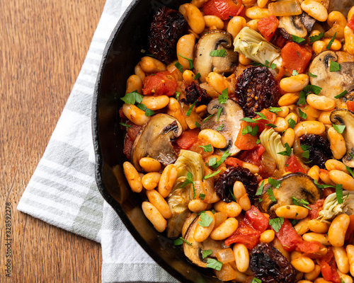 TUSCAN WHITE BEAN SKILLET WITH TOMATOES, MUSHROOMS, AND ARTICHOKES