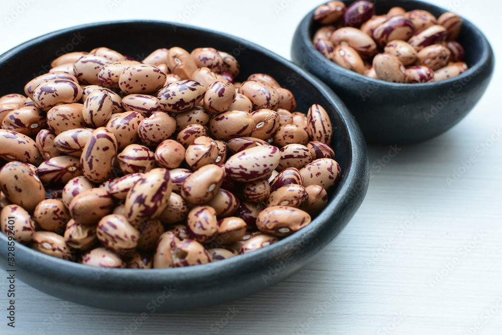 Raw bean grains (Phaseolus vulgaris) displayed in bowl Raw bean grains (Phaseolus vulgaris) displayed in bowl