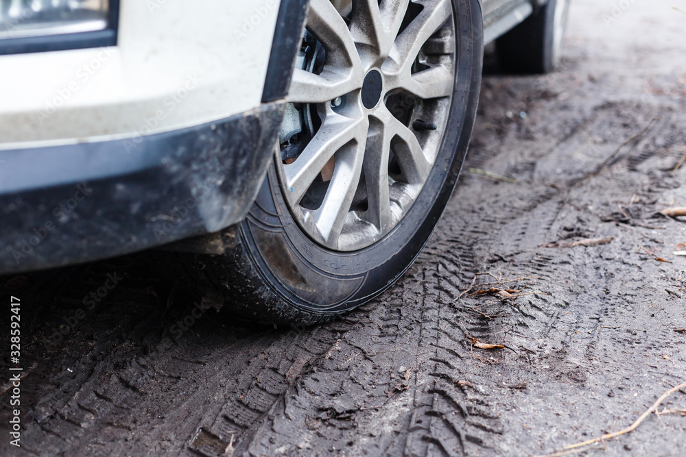 wheels of a white car in the mud wheels of a white car in the mud