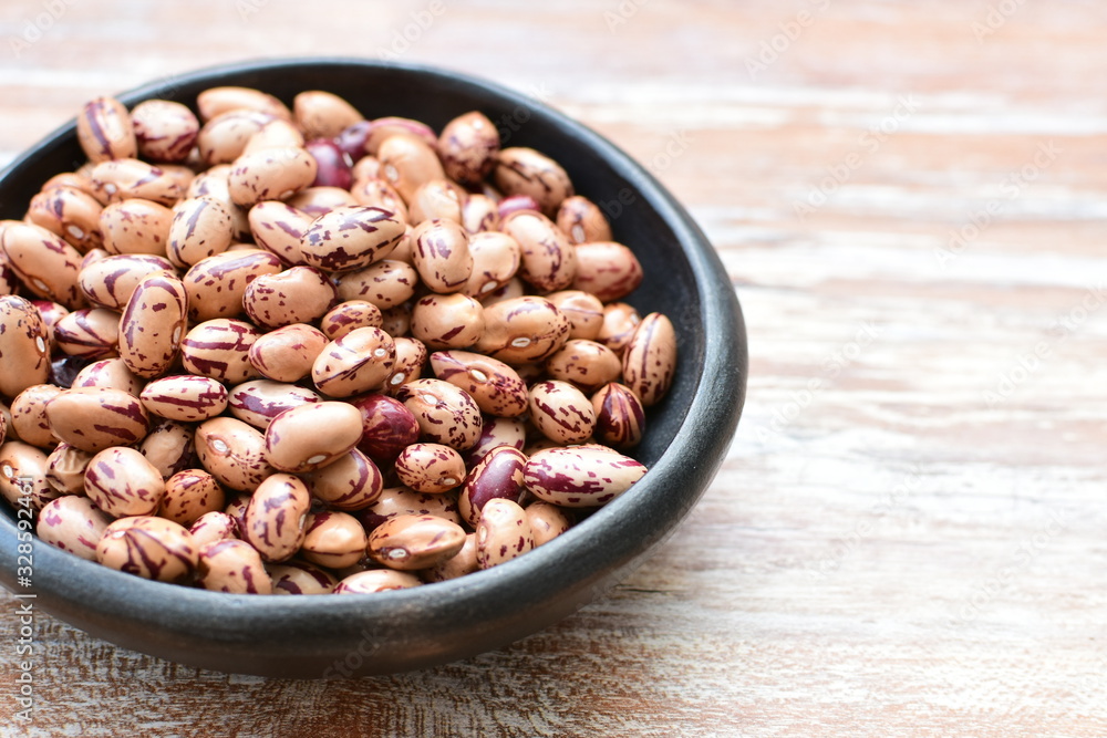 Raw bean grains (Phaseolus vulgaris) displayed in bowl Raw bean grains (Phaseolus vulgaris) displayed in bowl