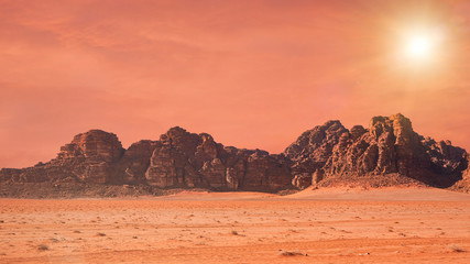 Papier peint photo Corail Planet Mars like landscape - Photo of Wadi Rum desert in Jordan with red colour filter and added sun, this location was used as set for many science fiction movies  © Lubo Ivanko