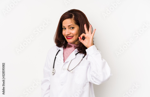 Middle age latin doctor woman isolated cheerful and confident showing ok gesture.