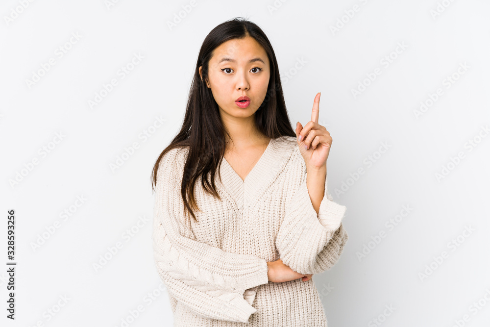 Young chinese woman isolated having some great idea, concept of creativity. Young chinese woman isolated having some great idea, concept of creativity.