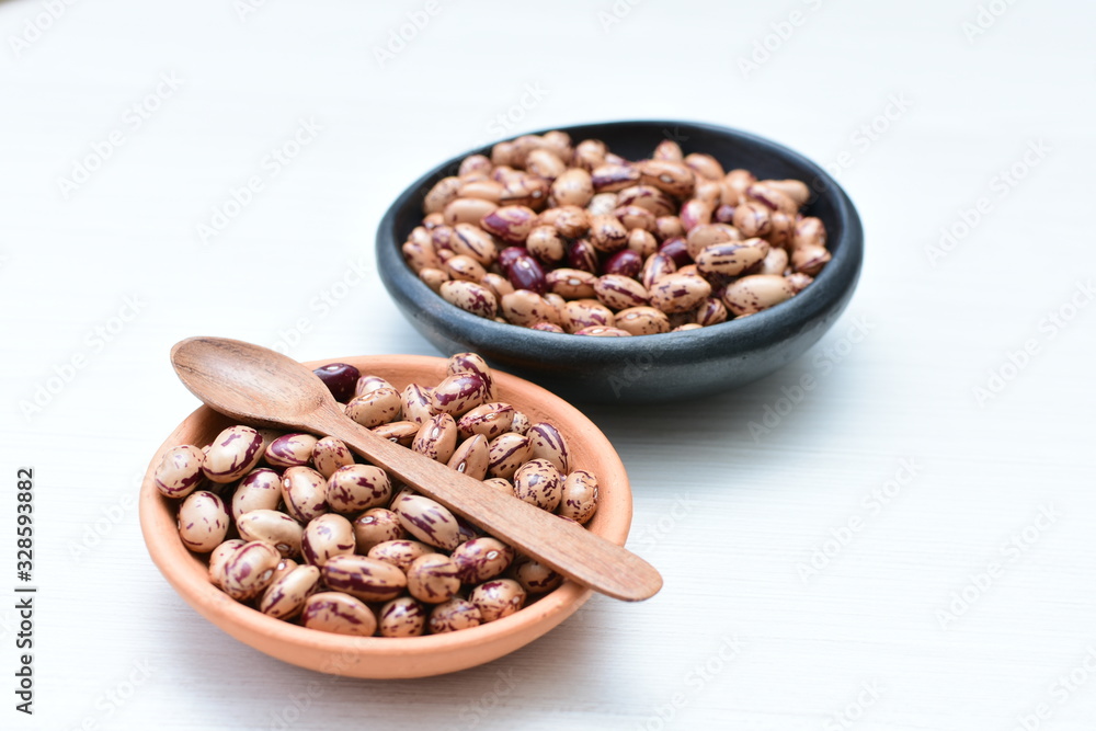 Raw bean grains (Phaseolus vulgaris) displayed in bowl Raw bean grains (Phaseolus vulgaris) displayed in bowl