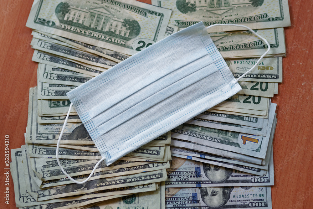 Medical mask and US dollars money. Concept of increasing the price of medical masks. Medical mask and US dollars money. Concept of increasing the price of medical masks.