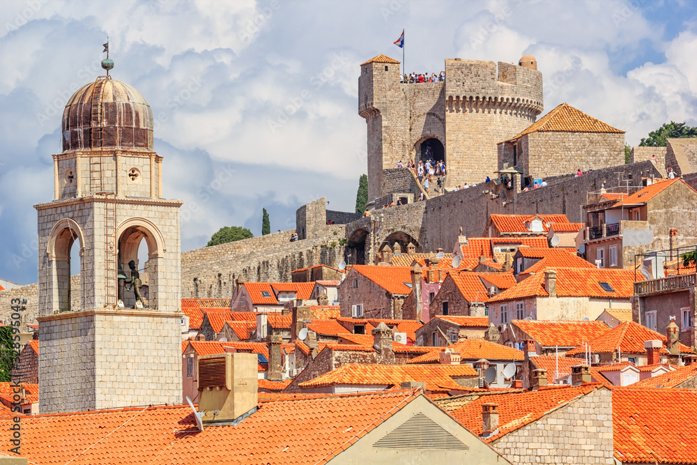 Summer mediterranean cityscape - view of the roofs of the Old Town of Dubrovnik on the background on of the city walls and of the Minceta Tower, Adriatic coast of Croatia