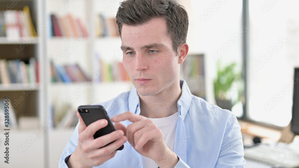 Young Student using Smartphone, Browsing Internet Young Student using Smartphone, Browsing Internet