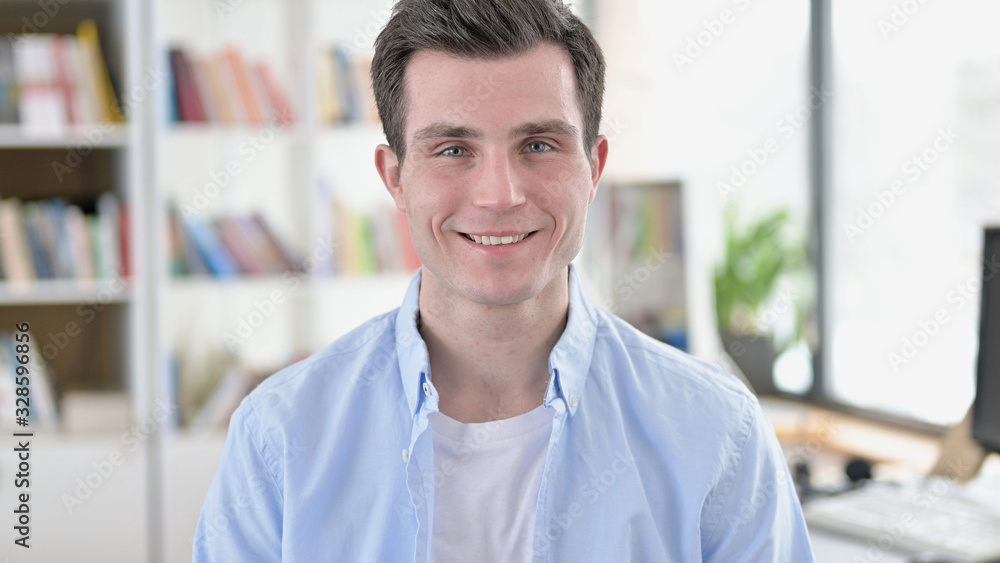 Fototapeta premium Smiling Young Man, Student Looking at Camera