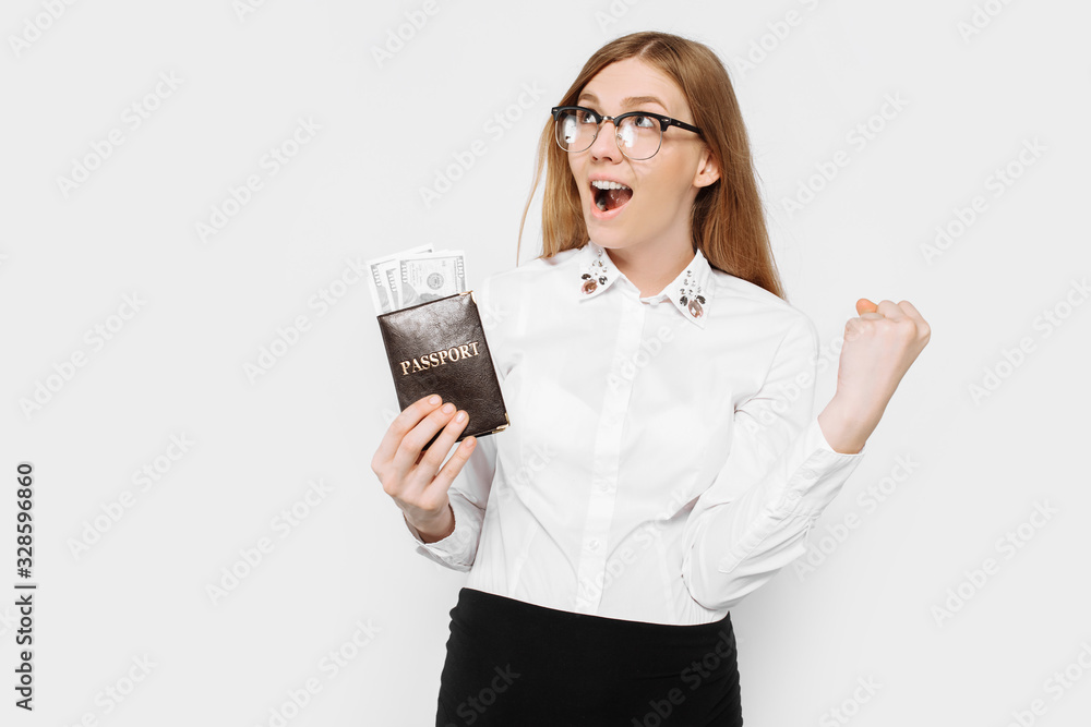 Image of a young pregnant businesswoman in glasses, shocked girl with passport and money, preparing for a long-awaited vacation Image of a young pregnant businesswoman in glasses, shocked girl with passport and money, preparing for a long-awaited vacation