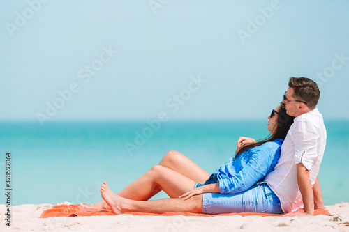 Young couple on white beach during summer vacation. © travnikovstudio