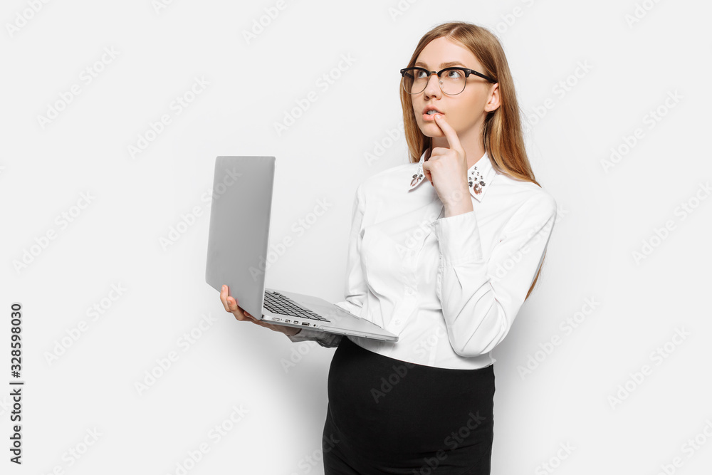 Image of young pregnant businesswoman in glasses pensive girl posing with laptop Image of young pregnant businesswoman in glasses pensive girl posing with laptop