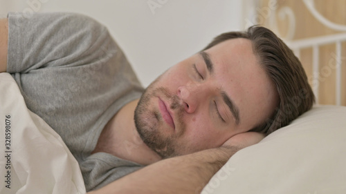 Portrait of Young Man Sleeping in Bed