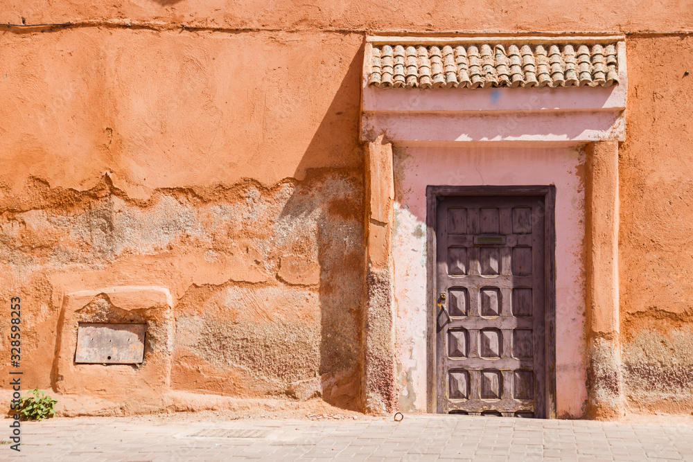 Image of wooden old door  and part of the house in Morocco.