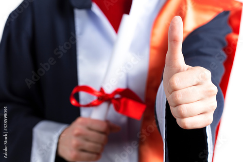 Graduation, Student holding a diploma in hand during the graduation success of the university, Concept education congratulations, Graduation Ceremony, In white background