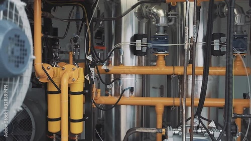Industrial technological premises of a modern factory with many yellow pipes and mechanisms