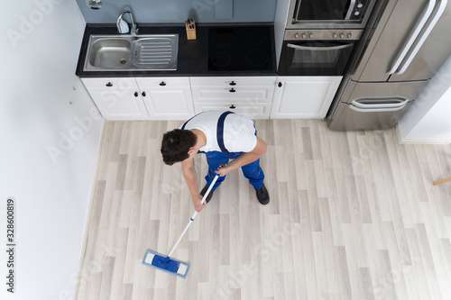 Man Cleaning Floor With Mop