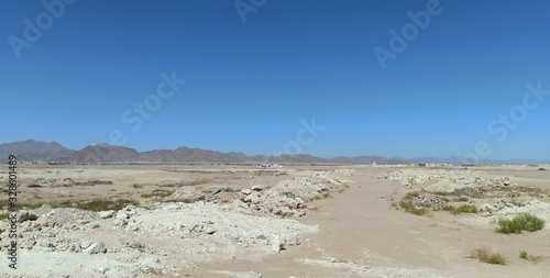 Desert landscape with rocky mountains without people. Sea resort on the desert coast