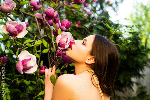 Beauty spring girl with magnolia Flovers. Tenderness sensual woman. Passion and sensual touch.