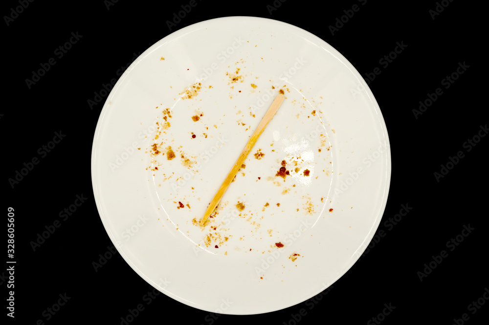 Crumbs and toothpick on plate Crumbs and toothpick on plate