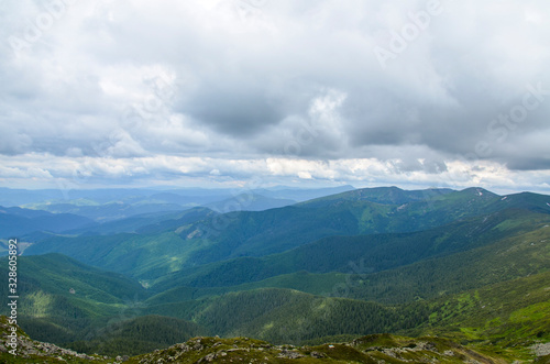 Beautiful view of mountains landscape with cloudy sky. Chornohora mountain ridge and beautiful cloudy sky from slopes of Pip Ivan mountain. 