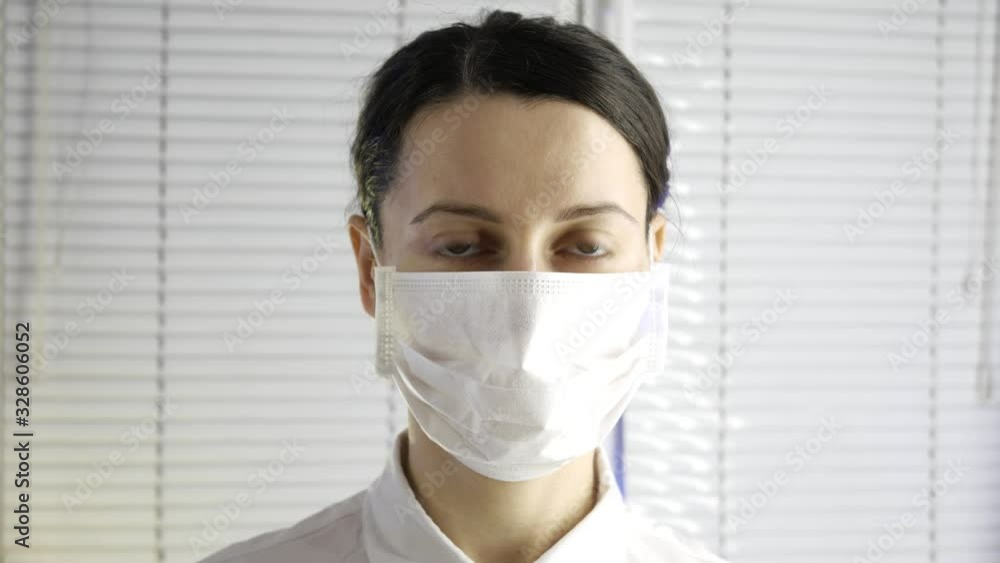 Closeup of young beautiful woman doctor in medical mask Closeup of young beautiful woman doctor in medical mask