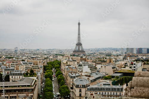 Top view on streets of Paris, buildings, roads with traffic and Eiffel tower  © Anna