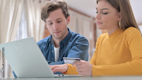 Serious Office Colleagues making Online Payment on Laptop