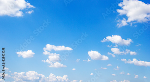 Blue sky background and white clouds soft focus, and copy space photo