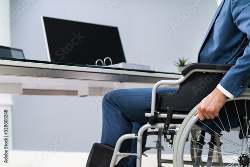 Close-up Of Businessman Sitting On Wheelchair