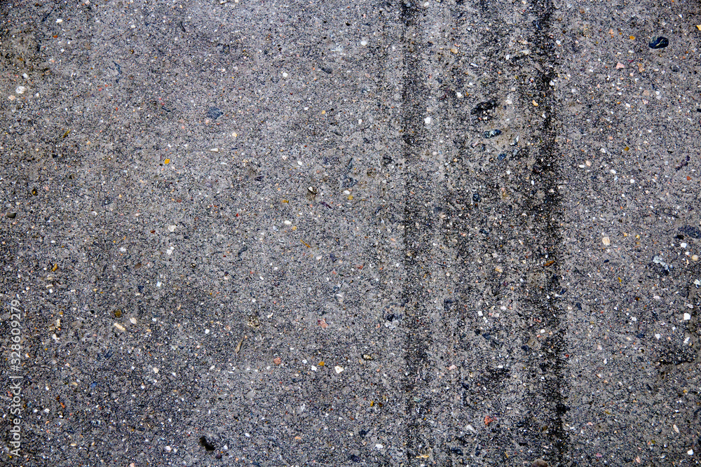 Tire tracks on the pavement. Background texture. Tire tracks on the pavement. Background texture.