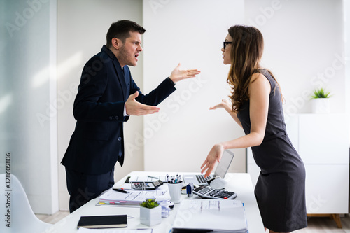 Businessman And Businesswoman Fighting