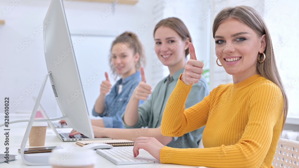 Obraz premium Ambitious Young Designer Team showing Thumbs Up