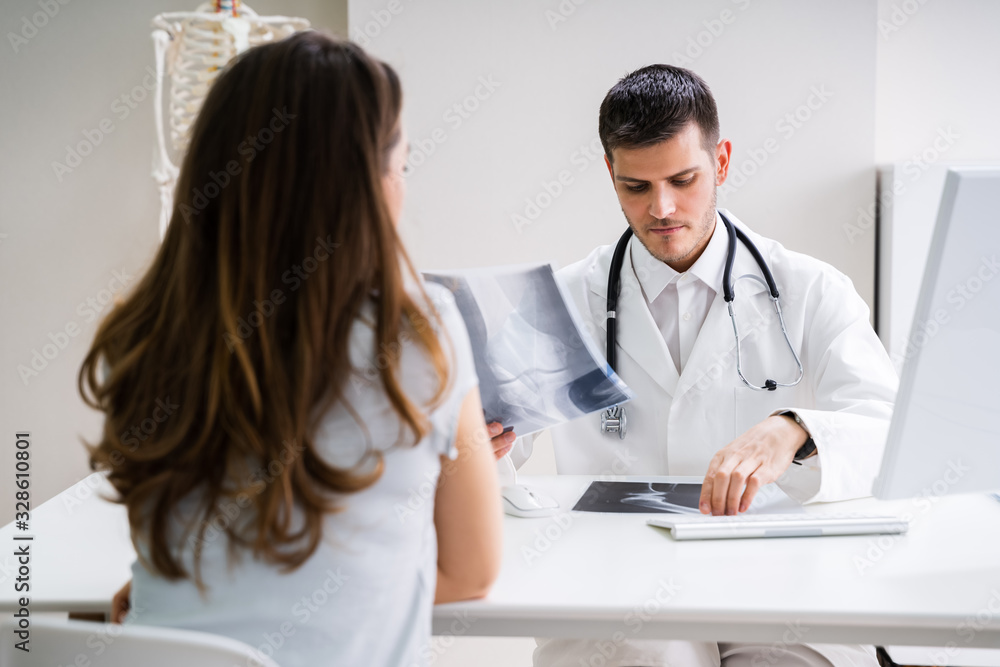 Doctor Having Discussion With Patient About X-ray