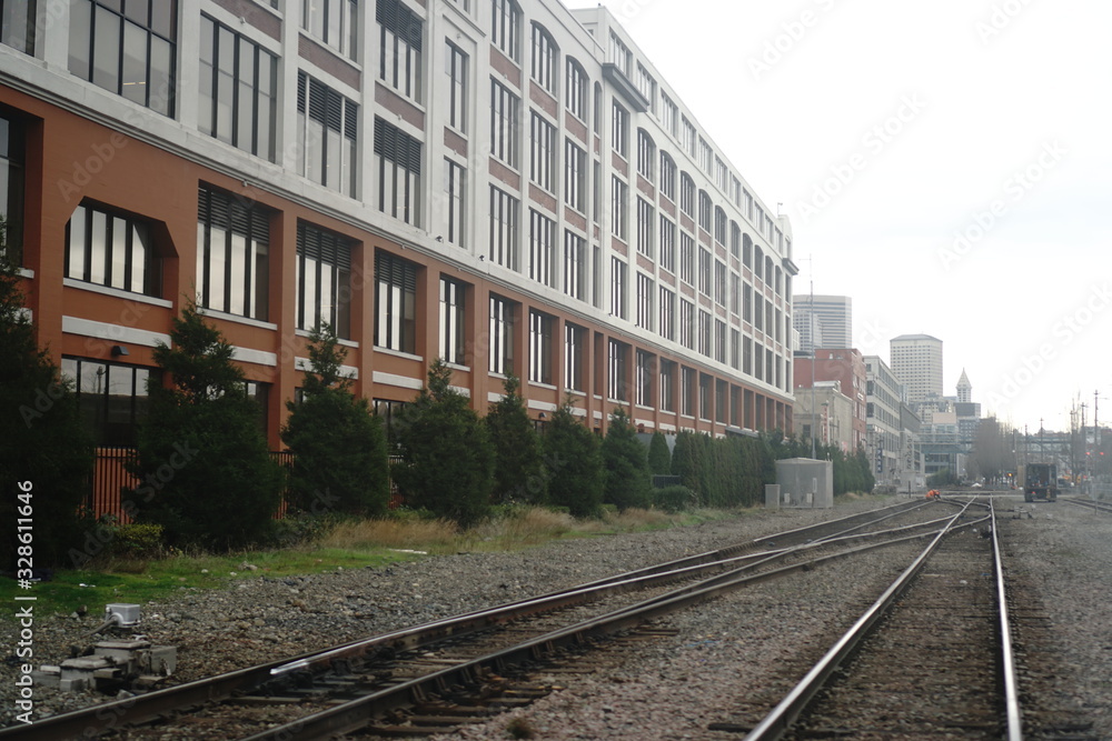 train tracks in fog by building