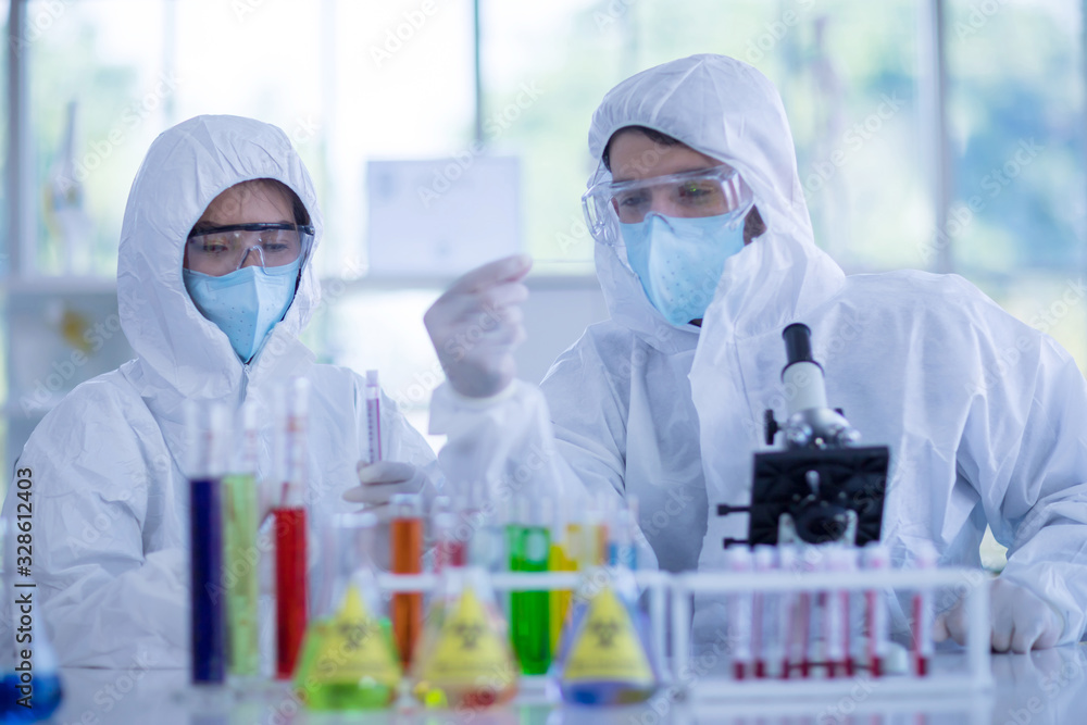 The Scientists are experimenting with chemicals in the laboratory. Concept, The scientists wear white protective clothing is experimenting with drug anti- Coronavirus, Covid2019 The Scientists are experimenting with chemicals in the laboratory. Concept, The scientists wear white protective clothing is experimenting with drug anti- Coronavirus, Covid2019