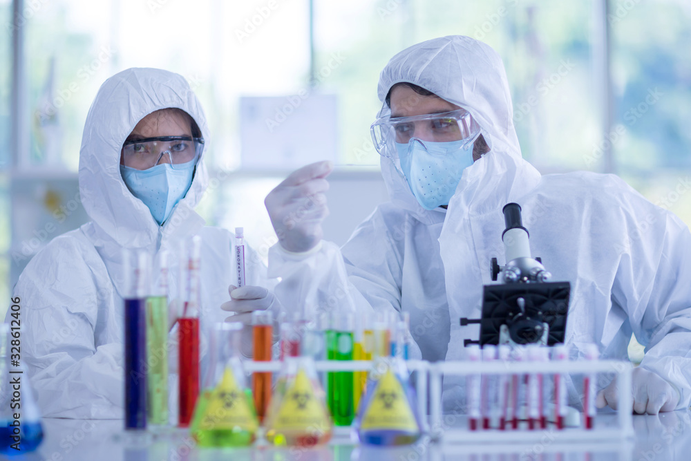 The Scientists are experimenting with chemicals in the laboratory. Concept, The scientists wear white protective clothing is experimenting with drug anti- Coronavirus, Covid2019