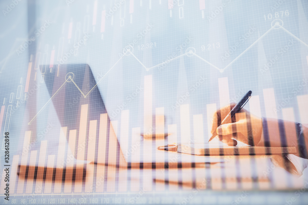 Multi exposure of forex chart with man working on computer on background. Concept of market analysis.