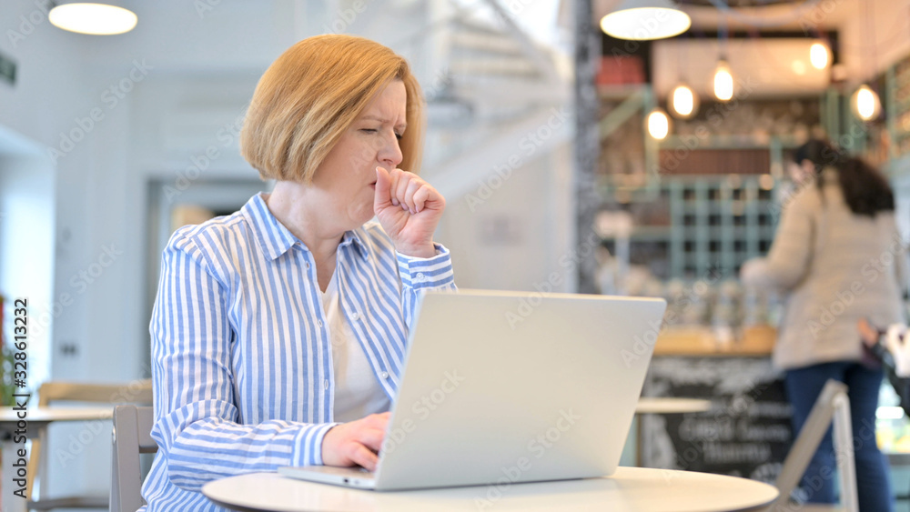 Creative Old Woman using Laptop Coughing in Cafe Creative Old Woman using Laptop Coughing in Cafe