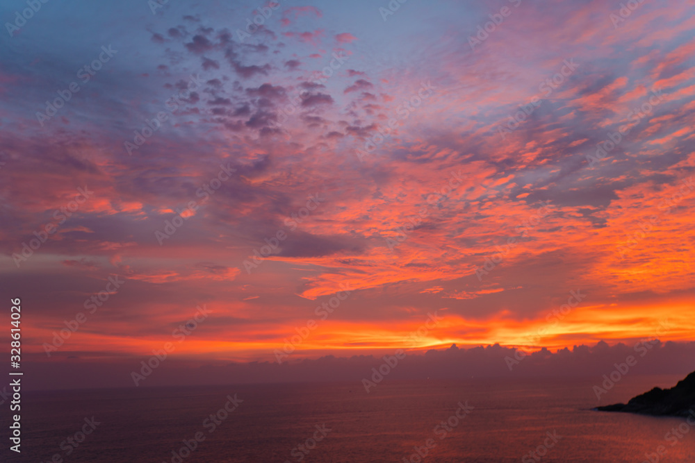 Colorful sunset sky with cloud above sea shore